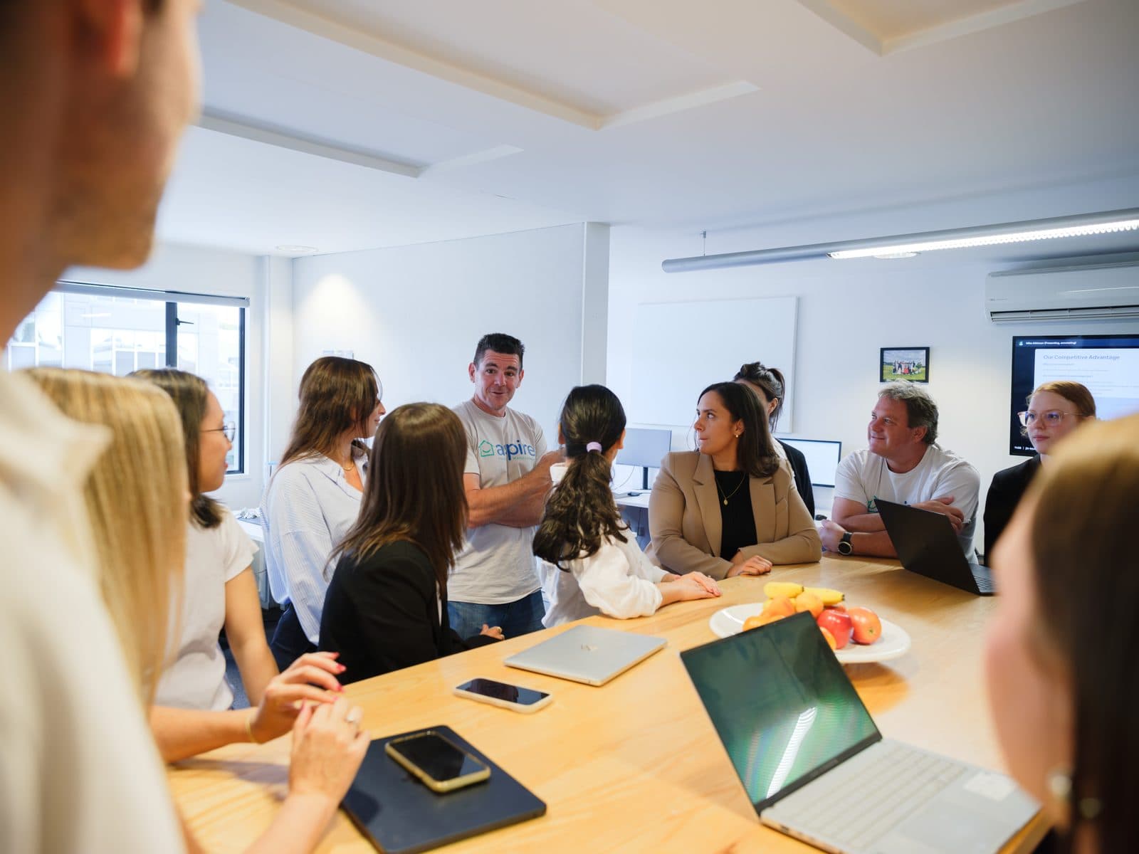 The Aspire team talking through the week around the boardroom table at the Takapuna office