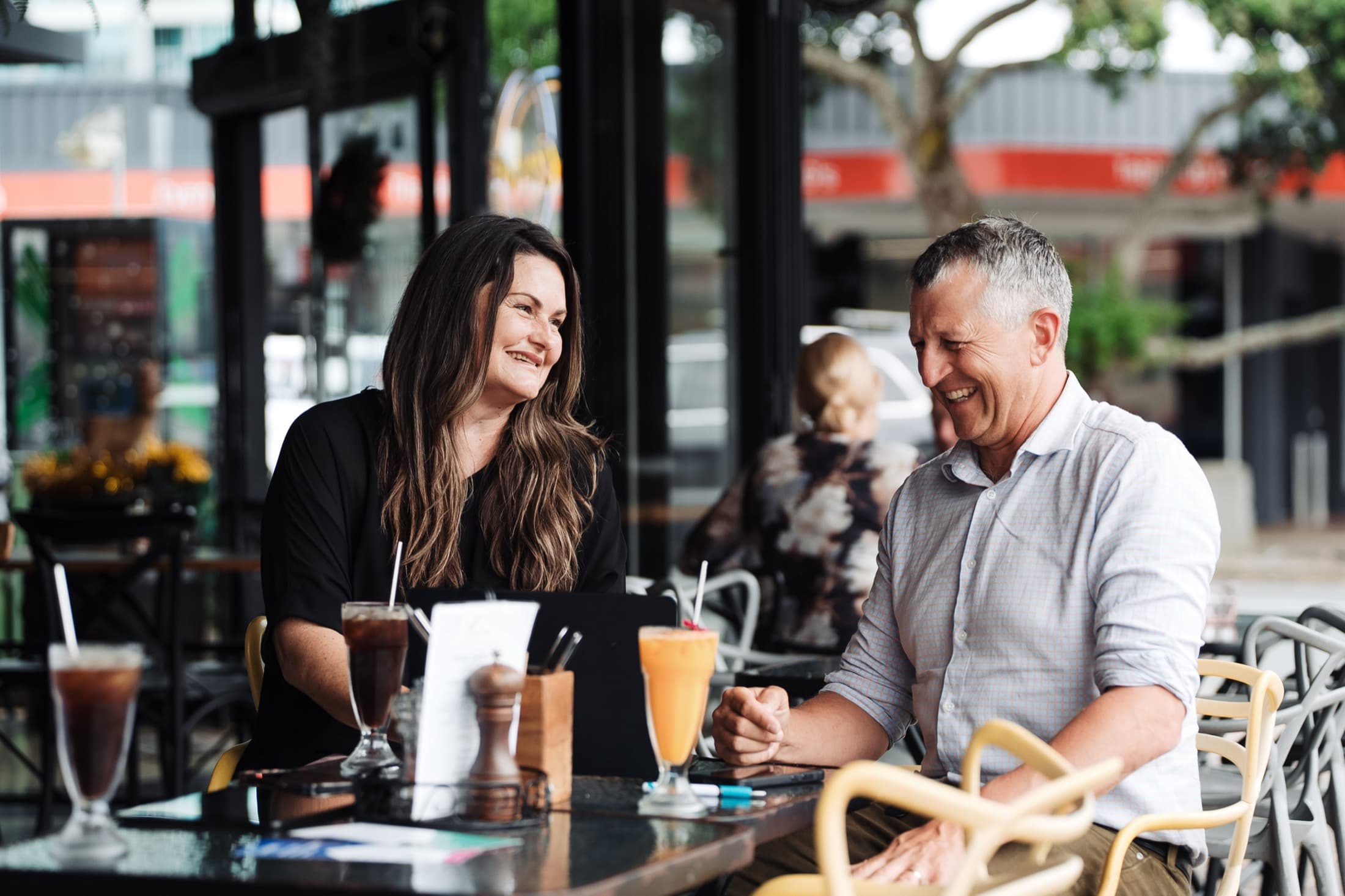 An Aspire property manager meeting a client over coffee